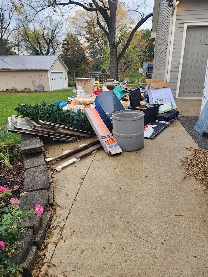 Dumpster being loaded with debris for Roofing Dumpster Rental in Moonachie